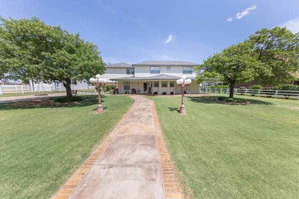 a view of a house with sitting area and garden