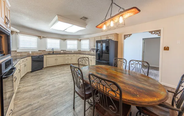 a dining room with furniture and window