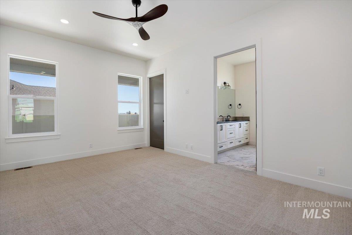 563 Moonstone Road Kimberly, ID 83341 - Photo 21 of 48 Recessed lighting, ceiling fan, two windows, and an en-suite bathroom with a double vanity