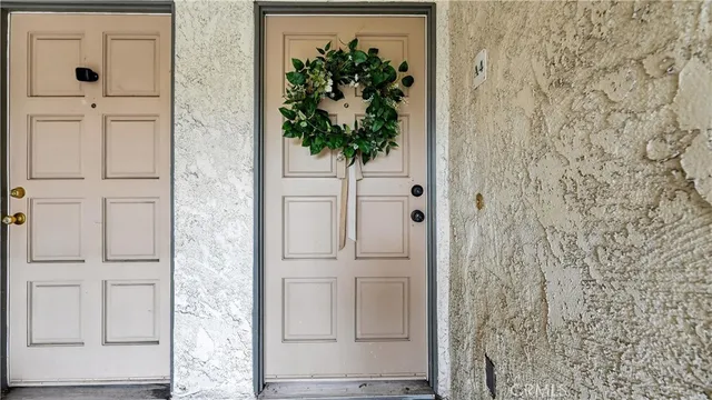 a living room with furniture a potted plant and a large window