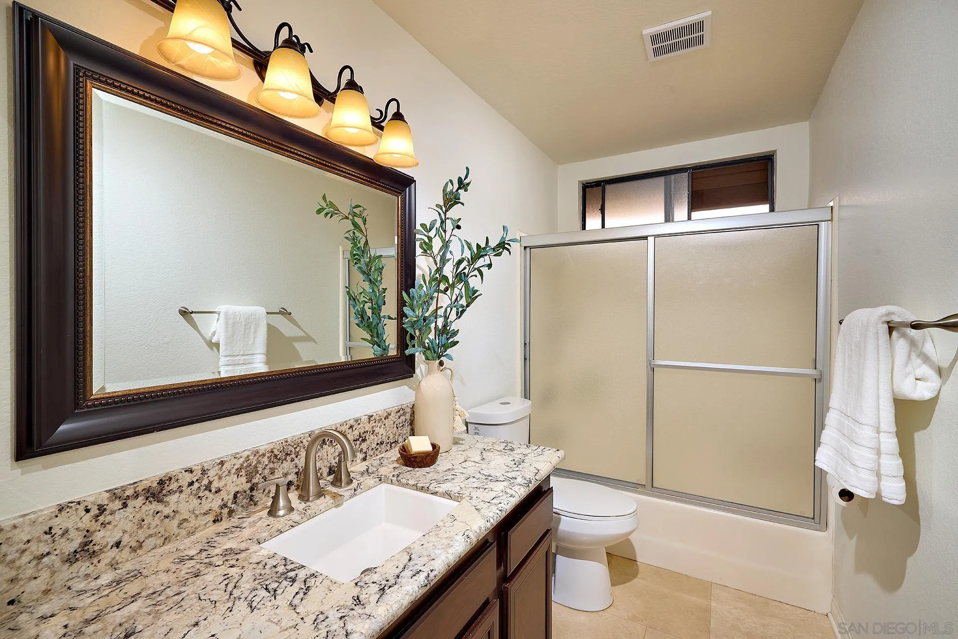 1960 Maverick Glen Escondido, CA 92027 - Photo 29 of 45 a bathroom with a granite countertop sink and a mirror
