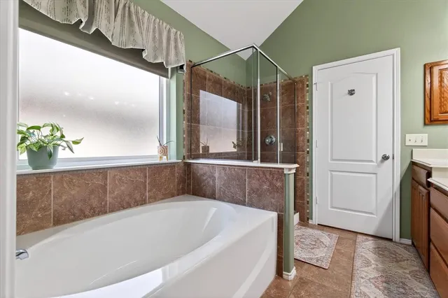 a bathroom with a tub and shower