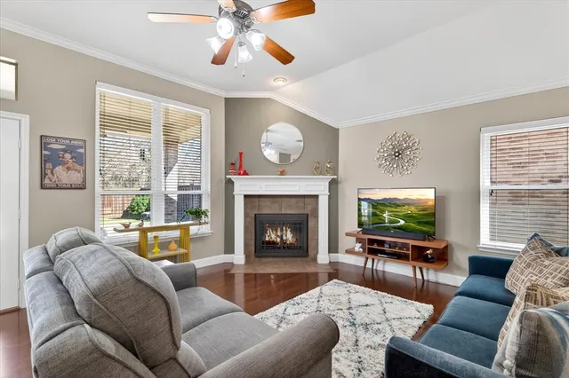 a living room with furniture a fireplace and a flat screen tv