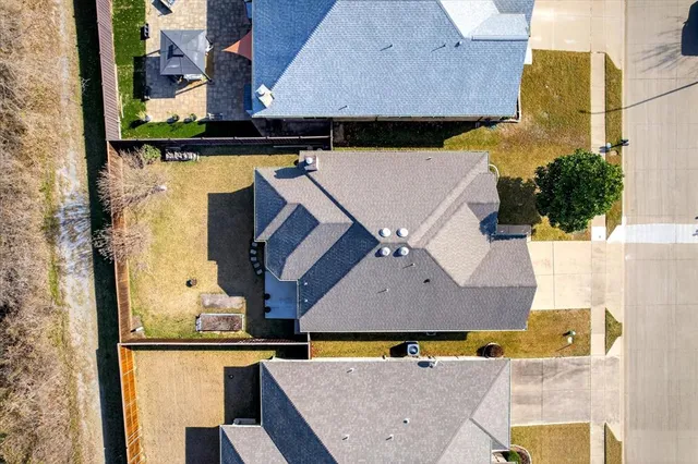 an aerial view of houses with outdoor space
