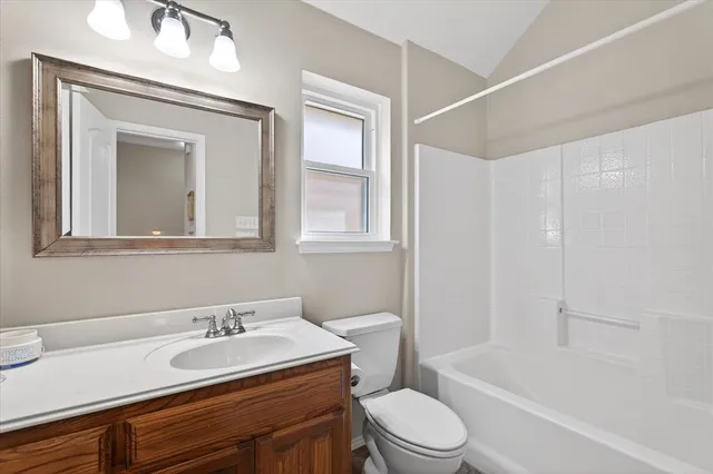 a bathroom with a sink toilet a mirror and shower