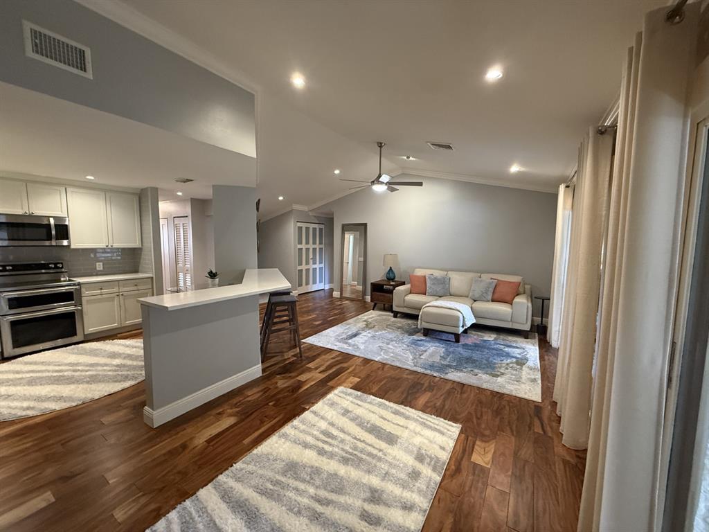 5560 Coach House Circle, Unit C Boca Raton, FL 33486 - Photo 11 of 31 a living room with furniture and a wooden floor