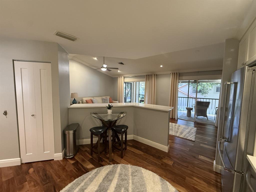 5560 Coach House Circle, Unit C Boca Raton, FL 33486 - Photo 13 of 31 a view of a dining room with furniture window and wooden floor