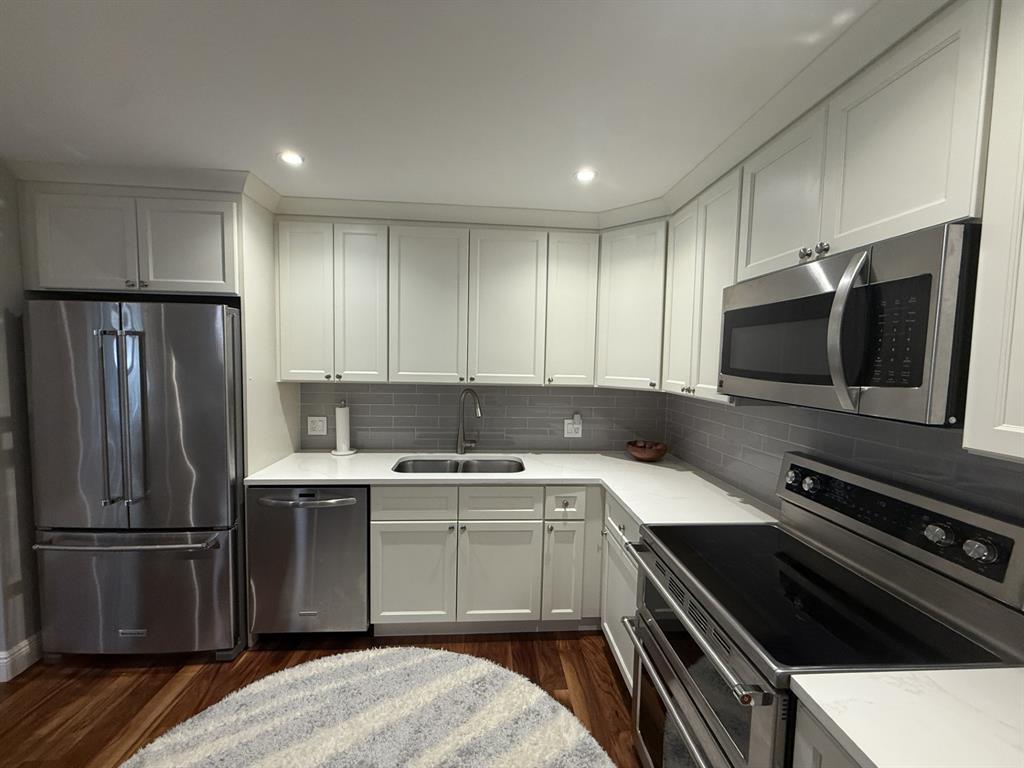 5560 Coach House Circle, Unit C Boca Raton, FL 33486 - Photo 15 of 31 a kitchen with a sink stainless steel appliances and cabinets