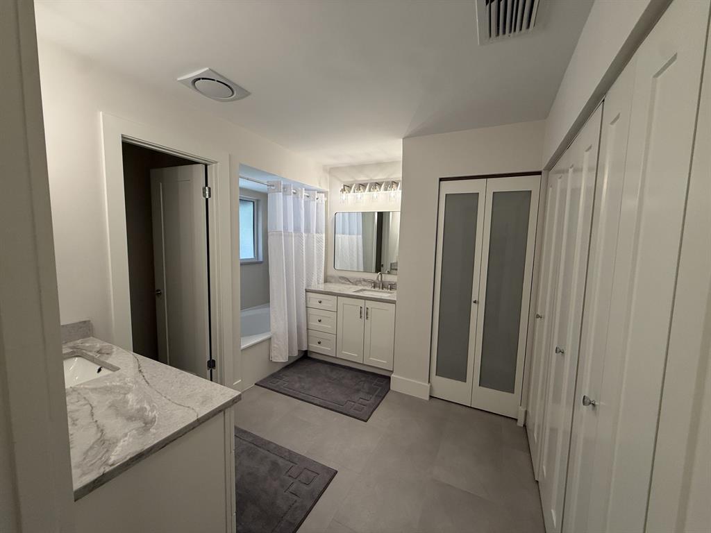 5560 Coach House Circle, Unit C Boca Raton, FL 33486 - Photo 21 of 31 a view of a kitchen with white cabinets