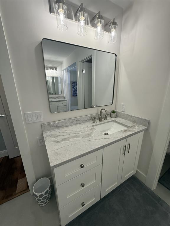 5560 Coach House Circle, Unit C Boca Raton, FL 33486 - Photo 23 of 31 a bathroom with a granite countertop sink and a mirror