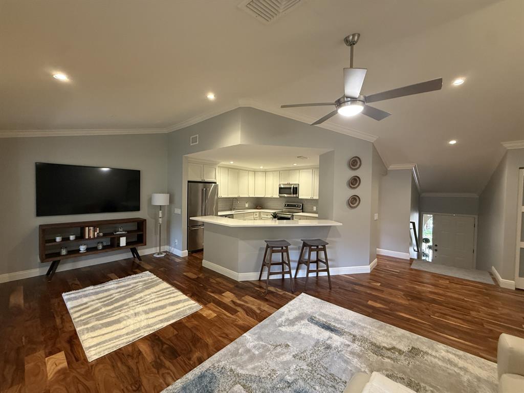 5560 Coach House Circle, Unit C Boca Raton, FL 33486 - Photo 9 of 31 a living room with furniture and a flat screen tv
