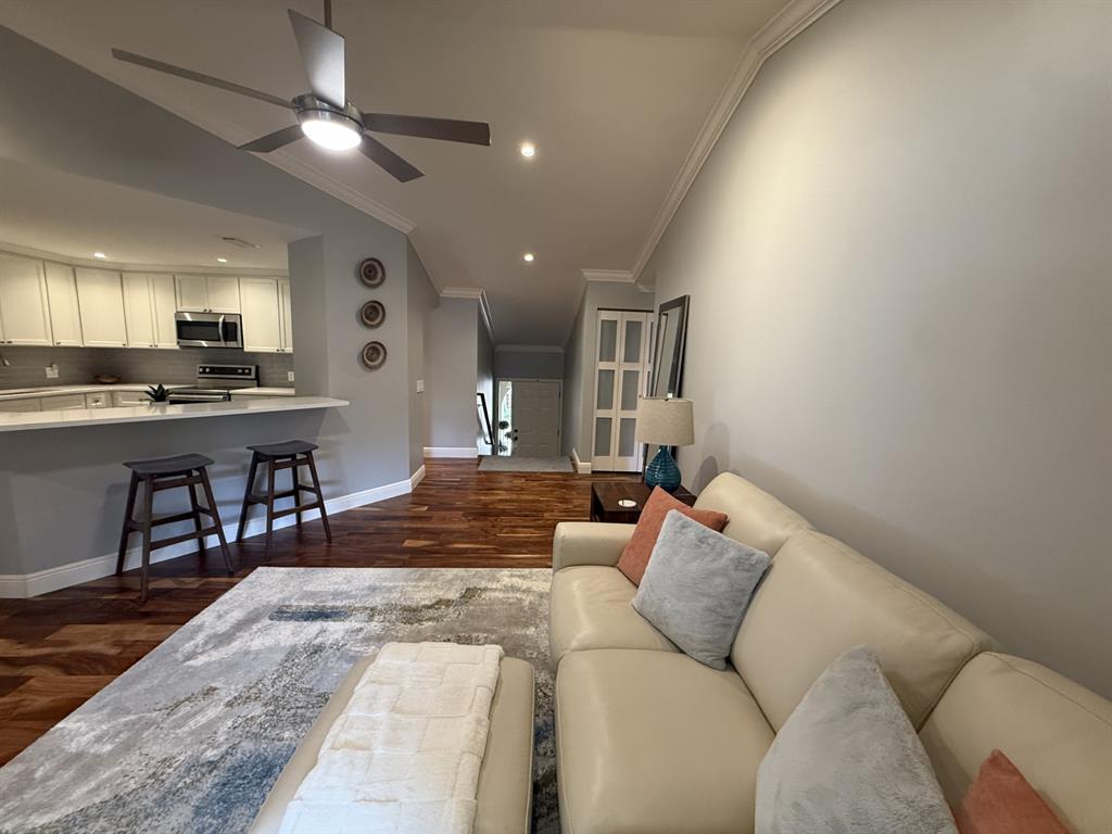 5560 Coach House Circle, Unit C Boca Raton, FL 33486 - Photo 10 of 31 a living room with furniture and a flat screen tv