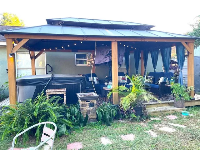 a view of front door of house with outdoor seating