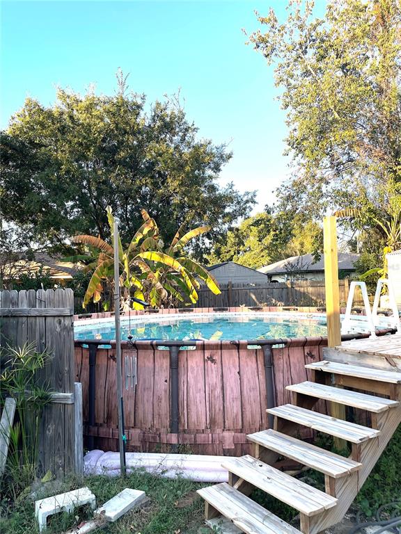 285 Northwest 65th Street Ocala, FL 34475 - Photo 14 of 18 a view of a backyard with wooden fence and a couple of flower plants