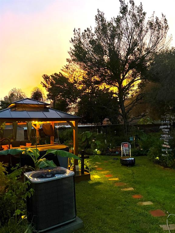 285 Northwest 65th Street Ocala, FL 34475 - Photo 2 of 18 a front view of a house with garden and sitting area