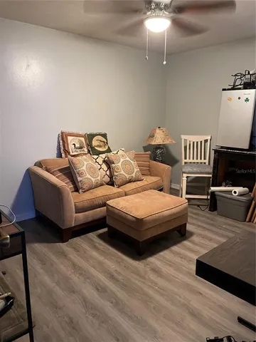 a spacious bedroom with a bed and wooden floor