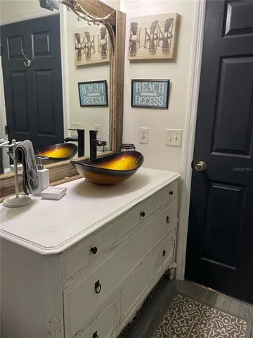 a view of a bathroom with a sink and a mirror