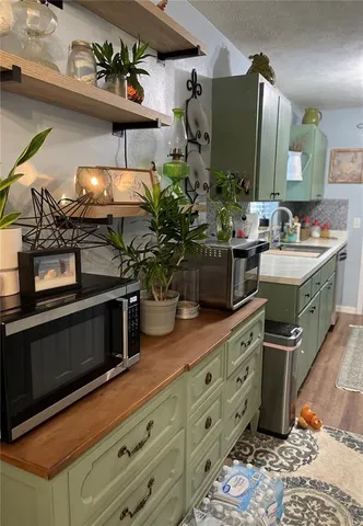 a kitchen with stainless steel appliances kitchen island granite countertop a stove a sink and a microwave