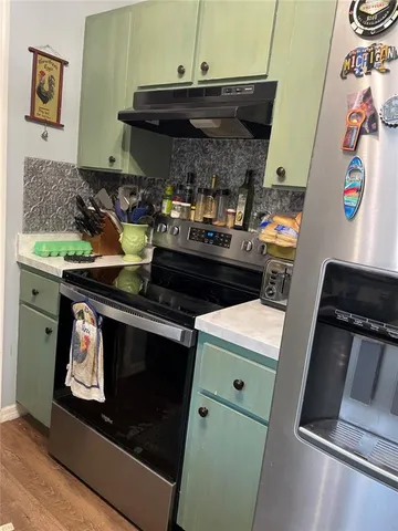 a kitchen with a stove and a microwave