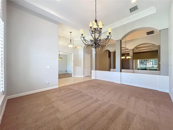 a view of an empty room with a chandelier