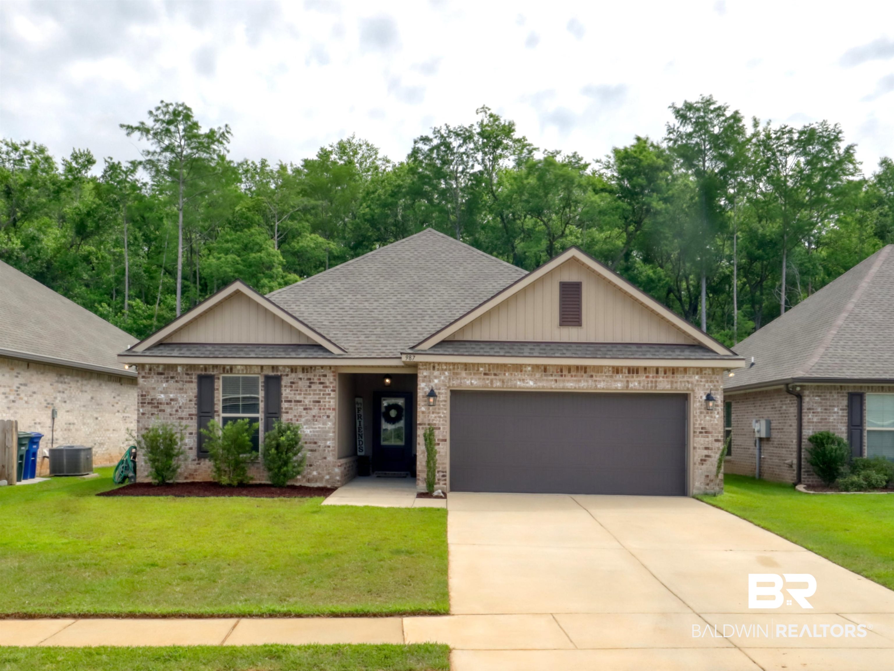 987 Gibson Court Foley, AL 36535 - Photo 2 of 34 View of front of property with a garage, driveway, a front yard, and brick siding