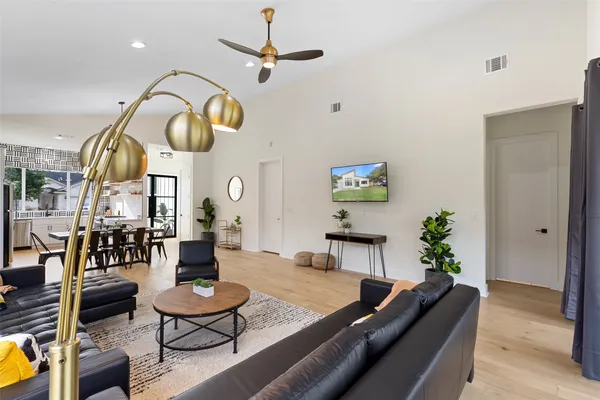 a living room with furniture and floor to ceiling windows
