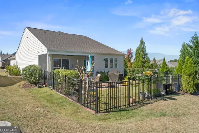 a view of a backyard with sitting area