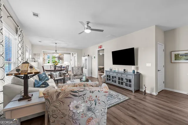 a living room with furniture and wooden floor