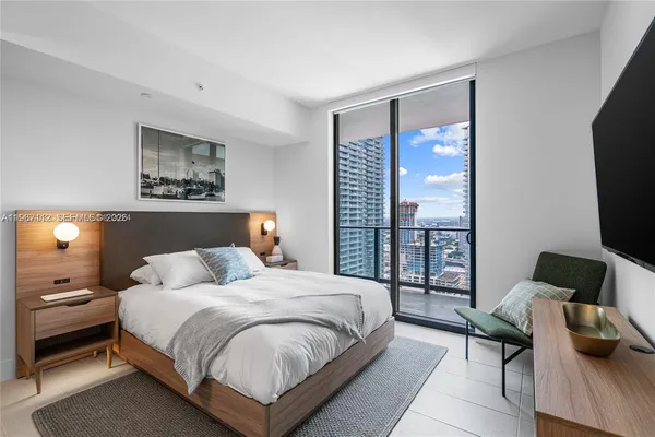 a bedroom with a bed and a television