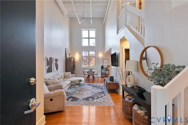 a living room with furniture a fireplace and a chandelier