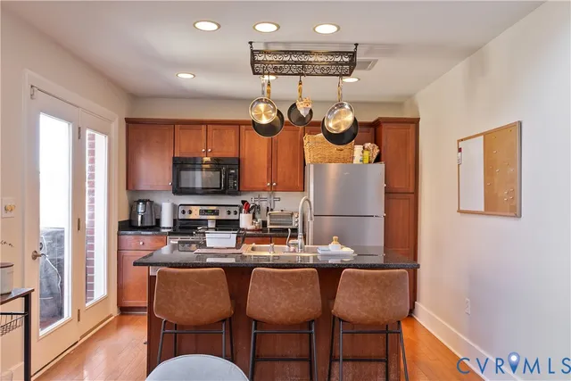 a dining room with granite countertop furniture and kitchen view