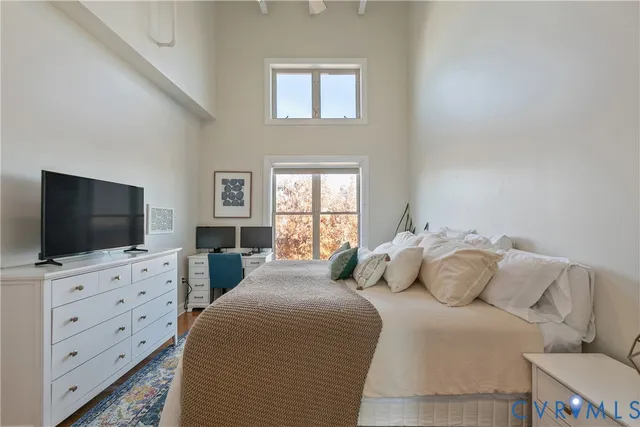 a bed room with a bed and a computer on a table