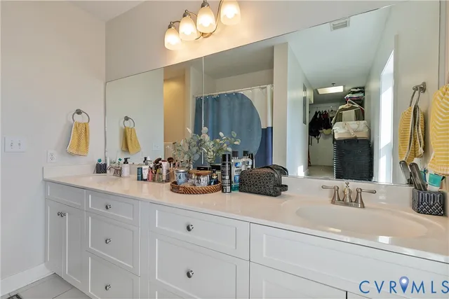 a view of walk in closet with clothes