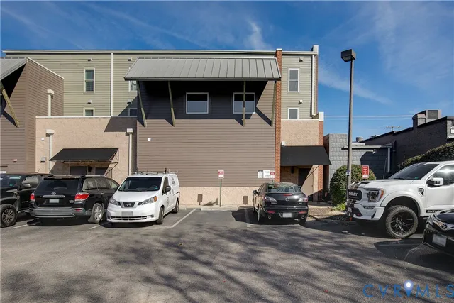 a view of a car park in front of a house