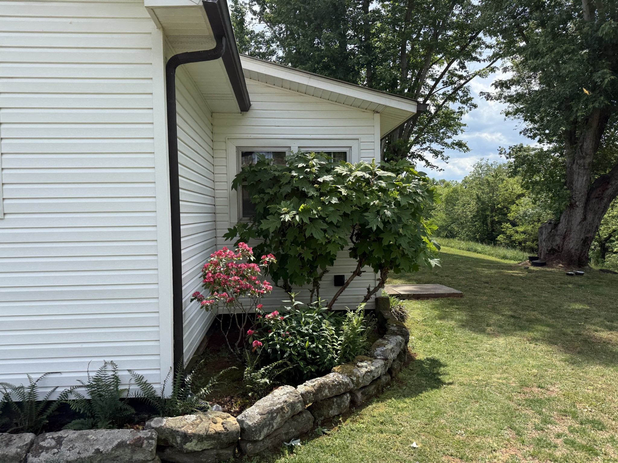 335 Nelson Cemetery Road Monroe, TN 38573 - Photo 39 of 81 a front view of a house with a yard and a garden
