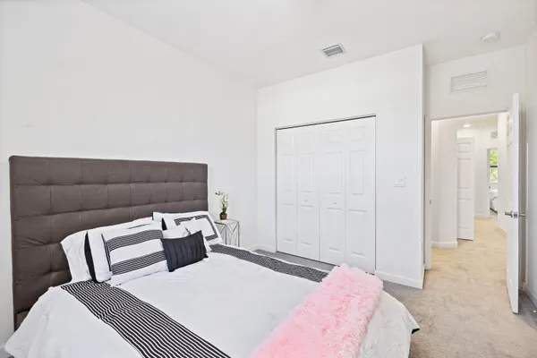 a bedroom with a bed and a couch