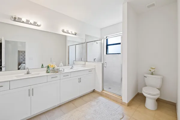 a spacious bathroom with a toilet sink and mirror