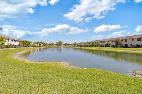 a view of a lake with houses in the back