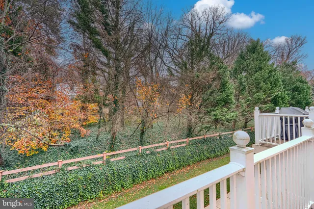 a view of a wooden fence and trees