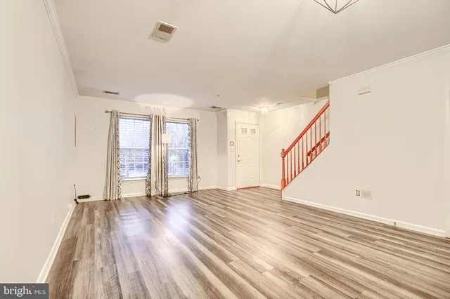 a view of an empty room with glass door