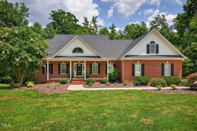 a front view of house with yard and green space