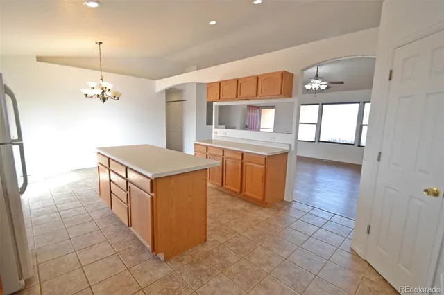 a kitchen with kitchen island cabinets and oven