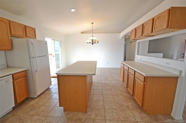 a kitchen with stainless steel appliances a refrigerator and a stove top oven