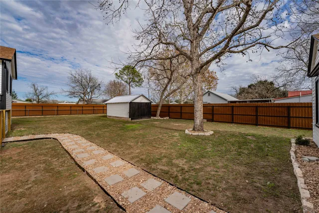 a view of a garden with wooden fence