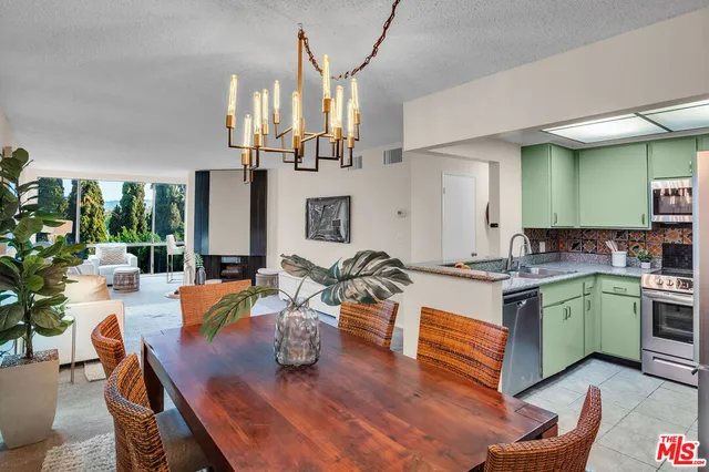 a kitchen with stainless steel appliances granite countertop a sink dishwasher and a stove with wooden floor