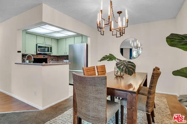 a dining room with furniture and a chandelier