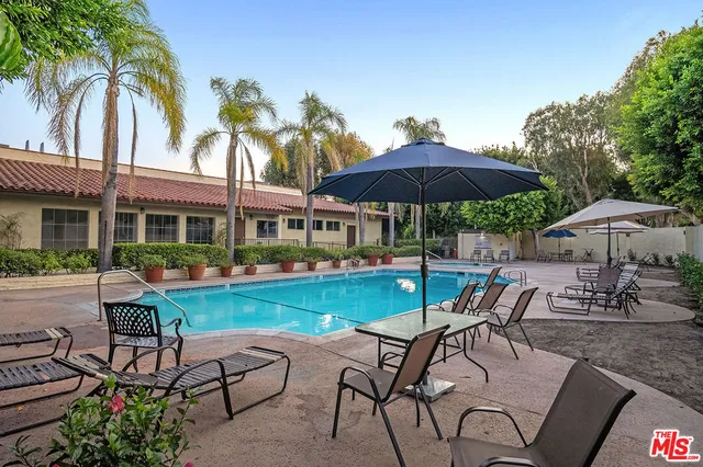a view of house with backyard and outdoor seating