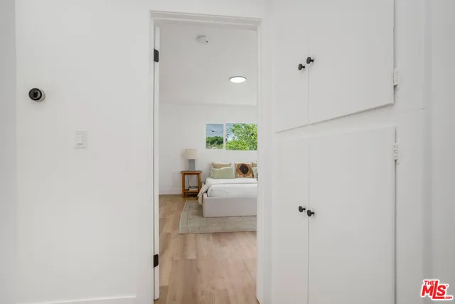 a bedroom with a bed and a large mirror