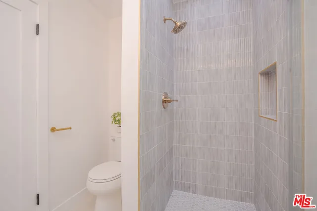 a bedroom with a bed and a potted plant