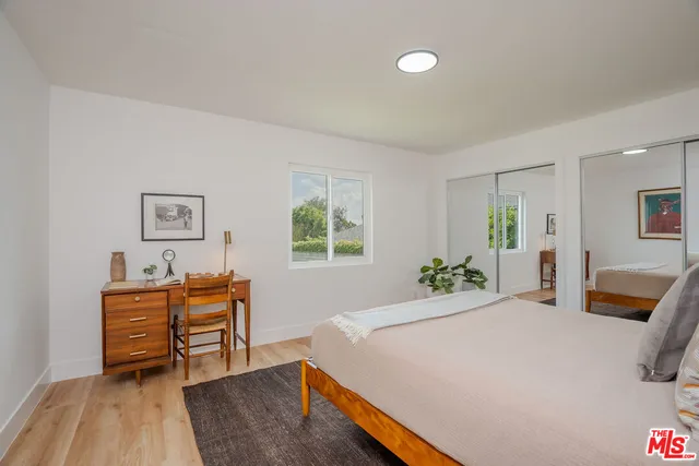 a bedroom with a bed and a table